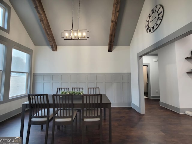 dining space with beam ceiling, dark hardwood / wood-style flooring, and a chandelier