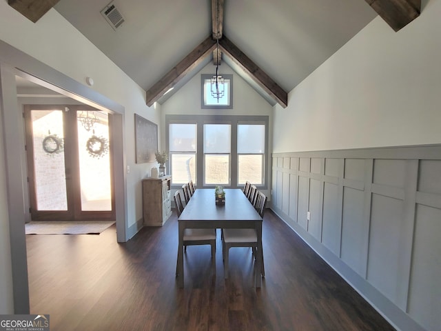 unfurnished dining area featuring dark hardwood / wood-style flooring, lofted ceiling with beams, and french doors