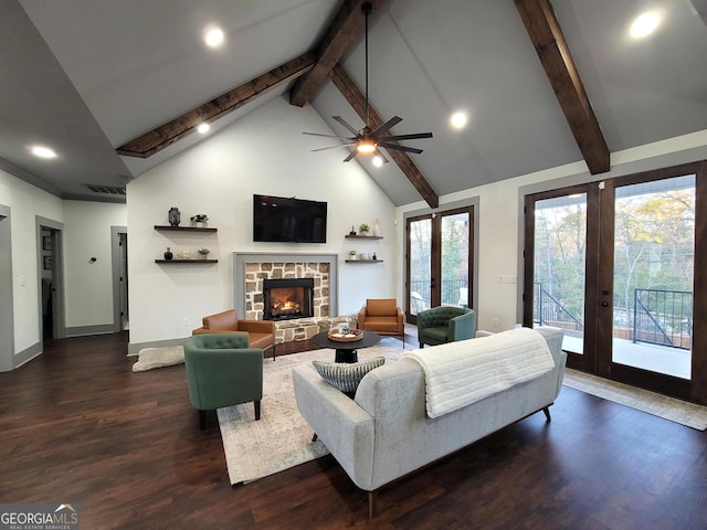 living room featuring french doors, a stone fireplace, dark wood-type flooring, and beam ceiling