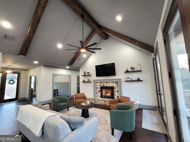 living room with beam ceiling, a stone fireplace, dark hardwood / wood-style flooring, high vaulted ceiling, and ceiling fan with notable chandelier