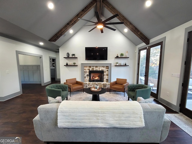 living room featuring french doors, ceiling fan, dark wood-type flooring, a fireplace, and vaulted ceiling with beams