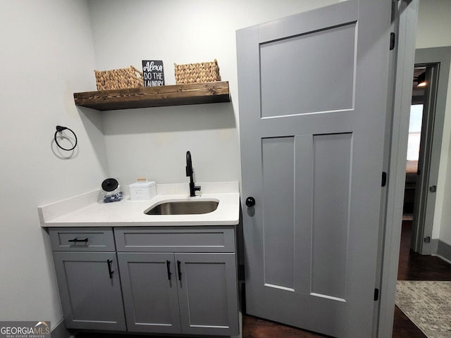 washroom with dark hardwood / wood-style flooring and sink