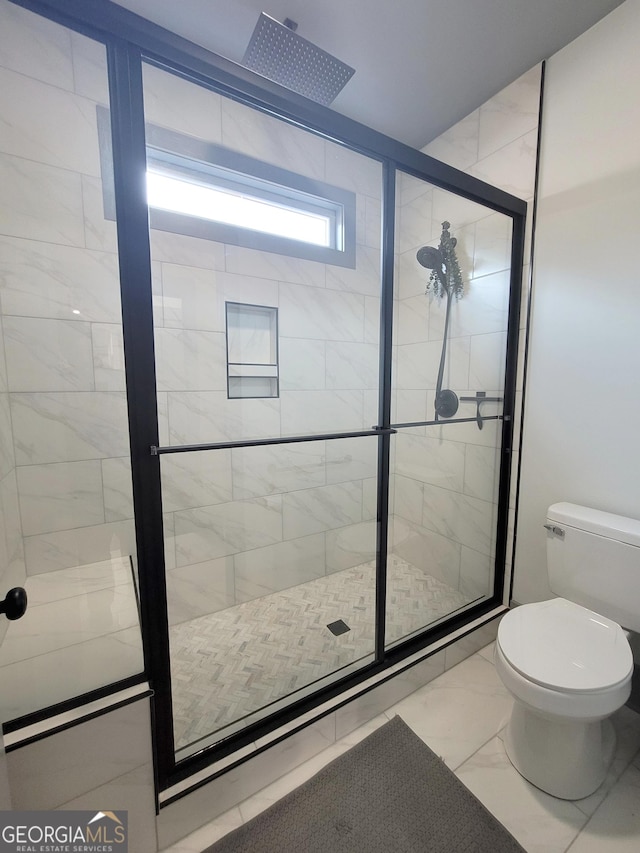 bathroom featuring toilet and an enclosed shower