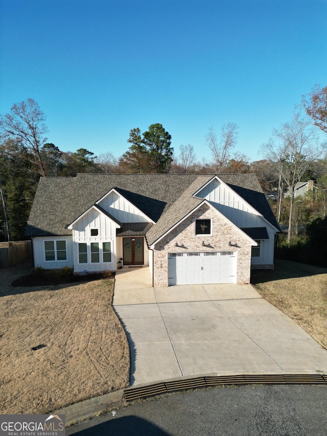 view of front of home with a garage and a front lawn