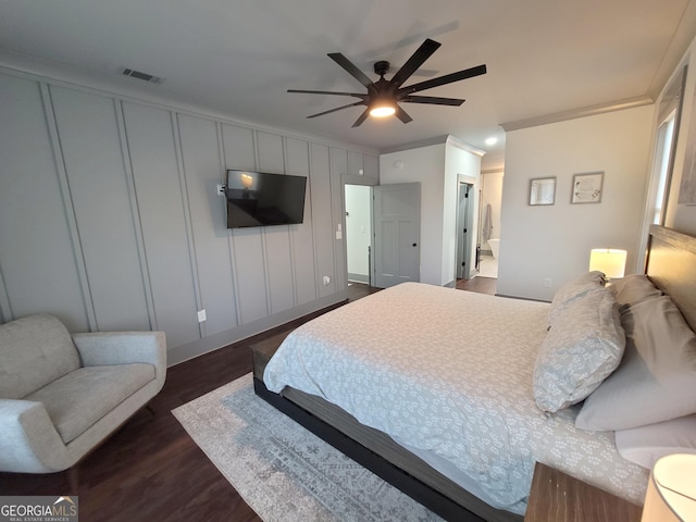 bedroom featuring connected bathroom, ceiling fan, dark wood-type flooring, and ornamental molding