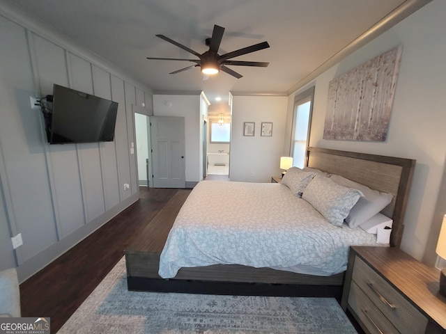 bedroom featuring ceiling fan, dark hardwood / wood-style flooring, ornamental molding, and connected bathroom