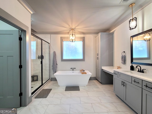 bathroom featuring vanity, separate shower and tub, and a chandelier