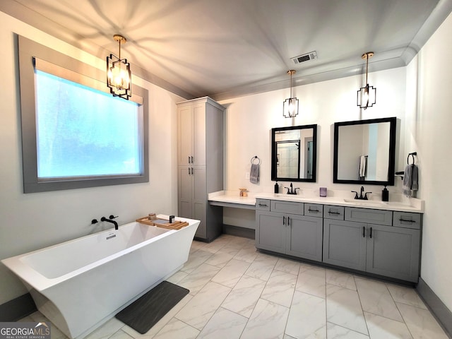 bathroom with a bathing tub, vanity, and a chandelier