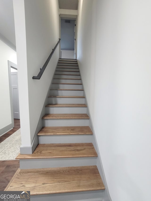 stairway with hardwood / wood-style flooring