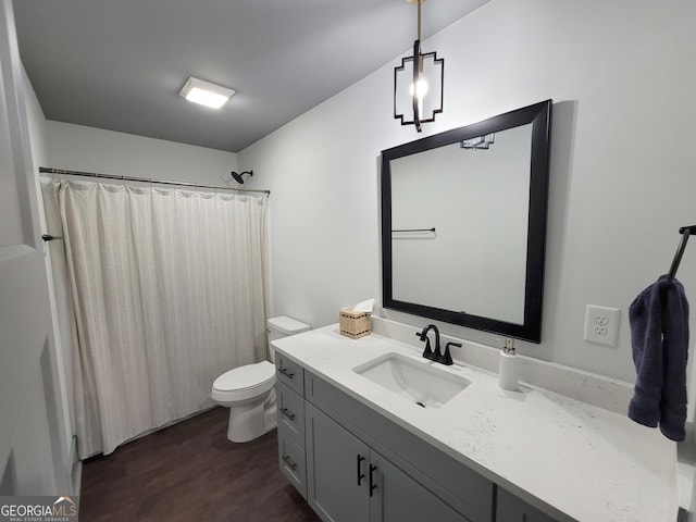 bathroom with a shower with shower curtain, vanity, toilet, and wood-type flooring