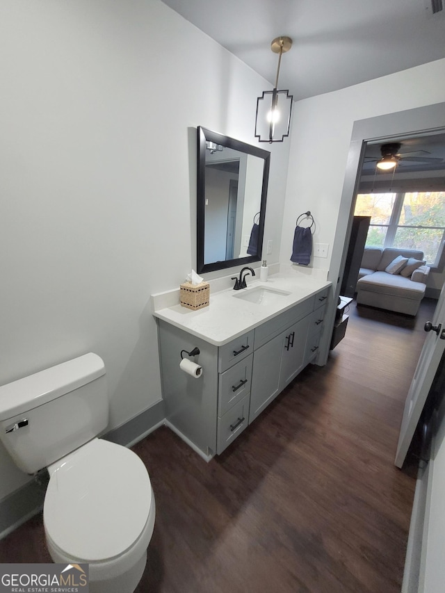 bathroom with hardwood / wood-style flooring, vanity, and toilet