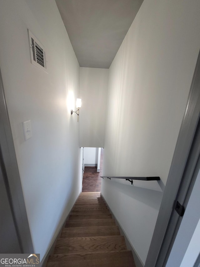 stairway featuring hardwood / wood-style floors