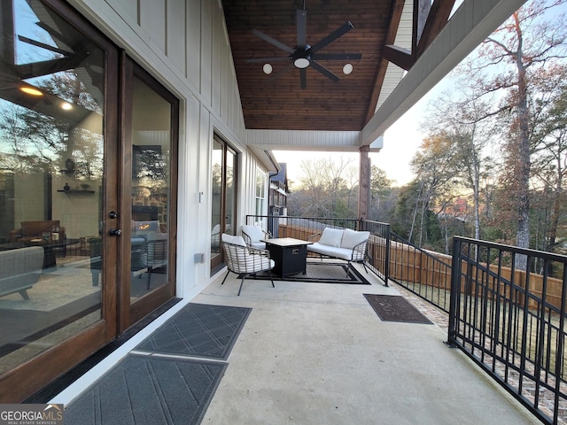 patio terrace at dusk with outdoor lounge area, ceiling fan, and french doors