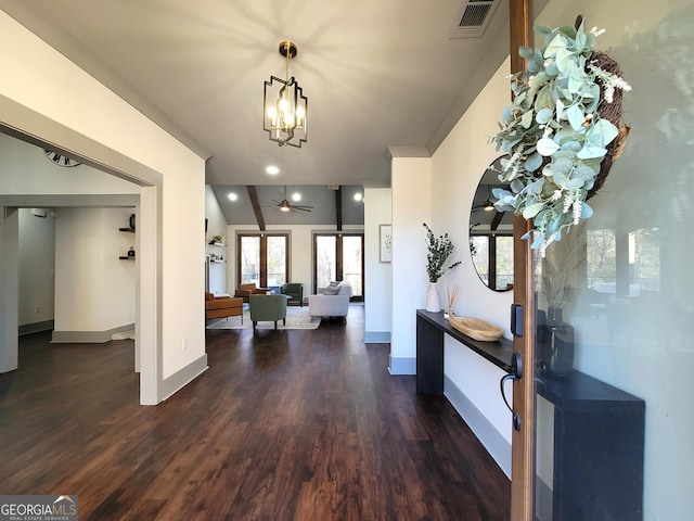 interior space with dark hardwood / wood-style flooring, ceiling fan with notable chandelier, and vaulted ceiling