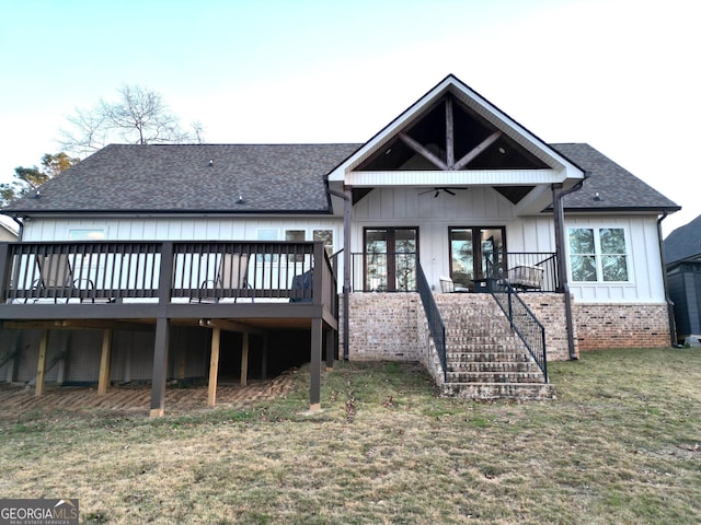 rear view of property with a yard, a deck, and ceiling fan