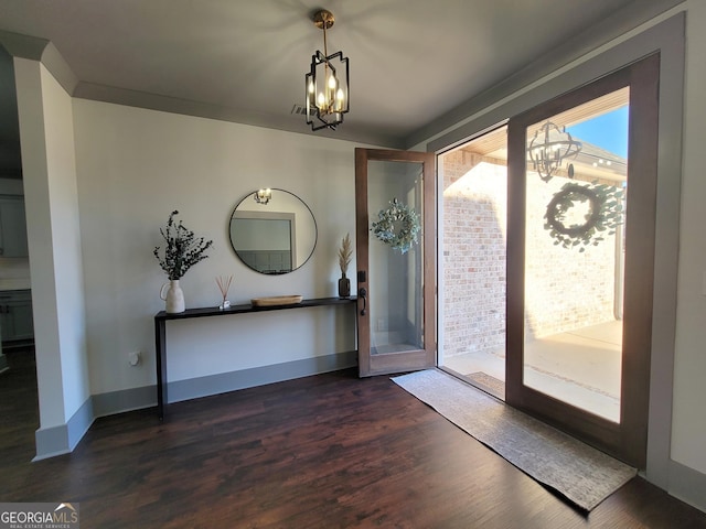 entrance foyer featuring dark hardwood / wood-style flooring, french doors, and a chandelier