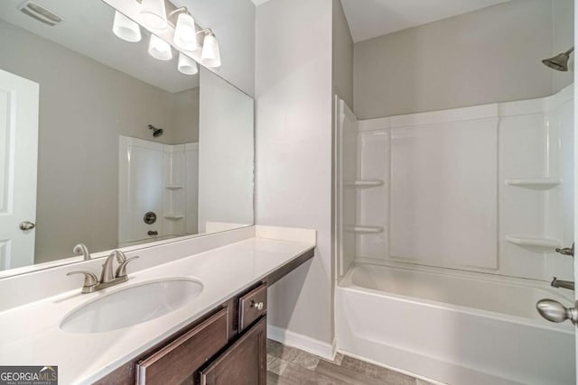 bathroom with shower / bathing tub combination, vanity, and hardwood / wood-style floors