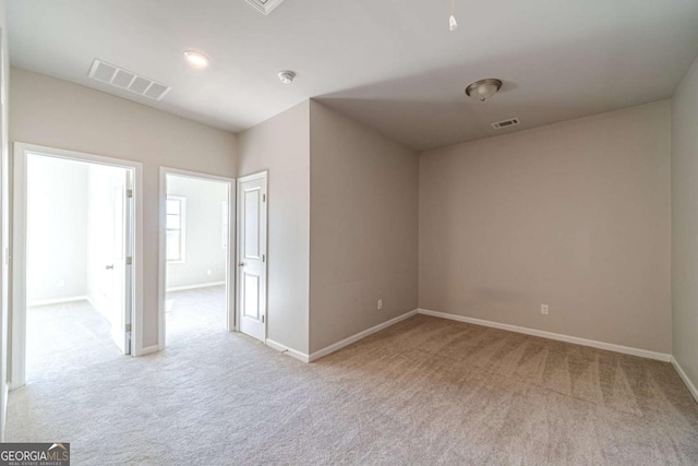 empty room featuring light colored carpet