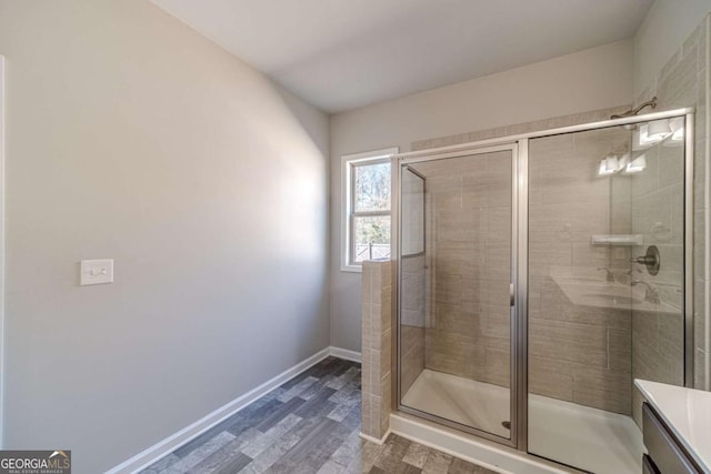 bathroom with hardwood / wood-style floors, vanity, and an enclosed shower