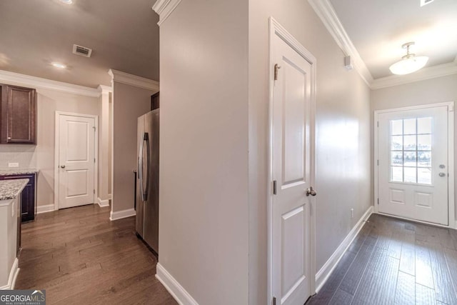 interior space featuring dark hardwood / wood-style floors, stainless steel fridge, dark brown cabinetry, and light stone countertops