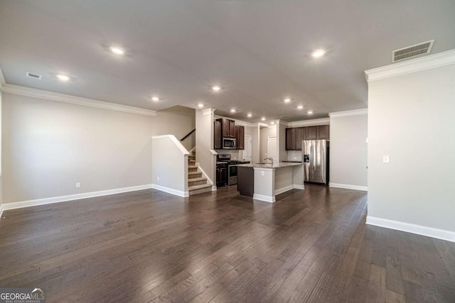 unfurnished living room with sink, ornamental molding, and dark wood-type flooring