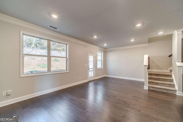 interior space with dark hardwood / wood-style flooring, plenty of natural light, and ornamental molding