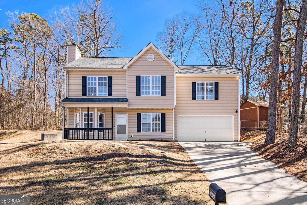 view of front of property featuring a porch and a garage