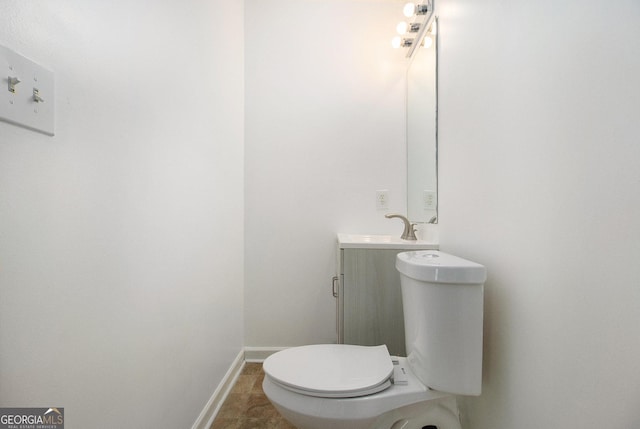 bathroom featuring vanity, tile patterned floors, and toilet