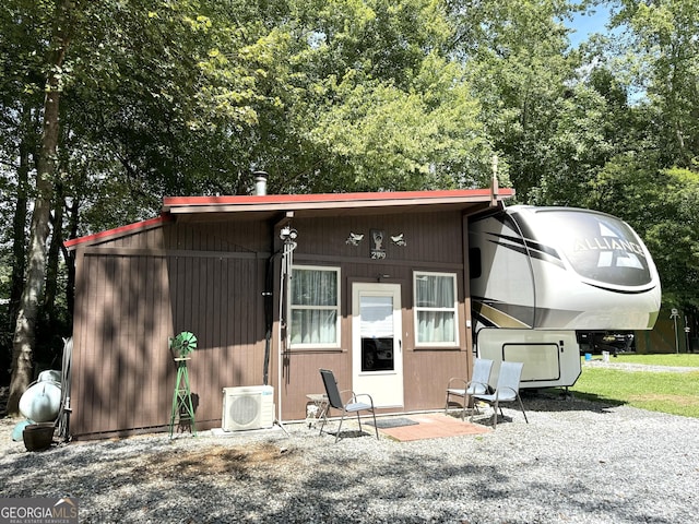 back of house featuring ac unit and a patio