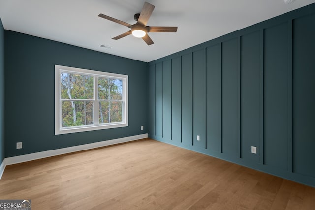 empty room with ceiling fan and light wood-type flooring