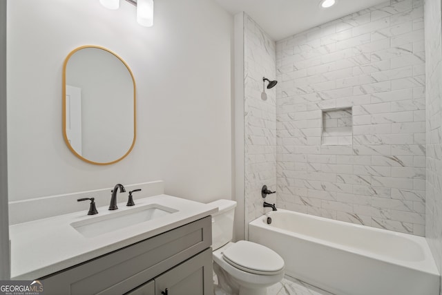 full bathroom with vanity, toilet, and tiled shower / bath