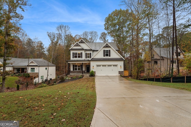 view of front of house with a front lawn, covered porch, and a garage