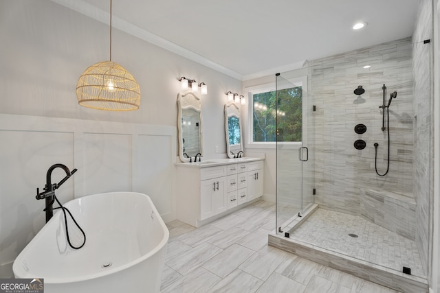 bathroom with plus walk in shower, vanity, and crown molding