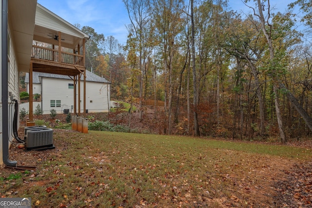 view of yard with a balcony, ceiling fan, and cooling unit