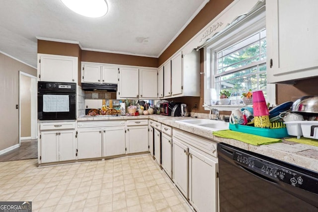 kitchen featuring sink, white cabinets, and black appliances