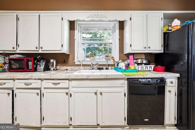 kitchen with white cabinetry, sink, and black appliances