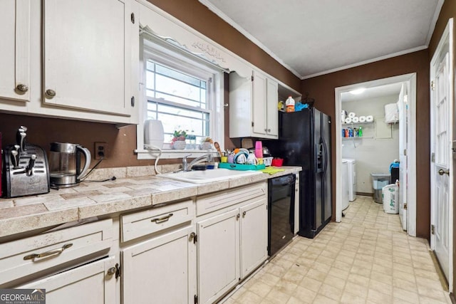 kitchen with washer and clothes dryer, dishwasher, crown molding, sink, and white cabinetry