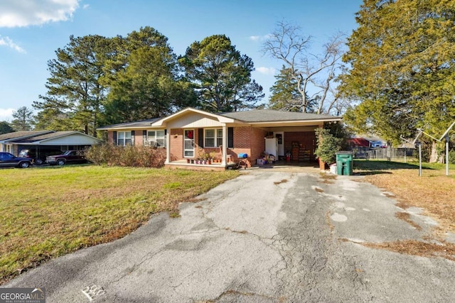 ranch-style home with a front yard and a carport