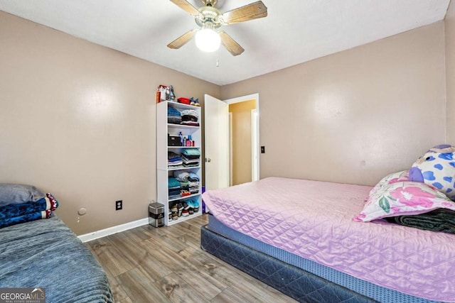 bedroom with hardwood / wood-style flooring and ceiling fan