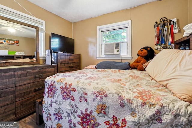 bedroom with ceiling fan and cooling unit