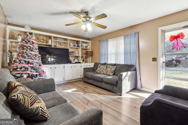 living room featuring light wood-type flooring and ceiling fan