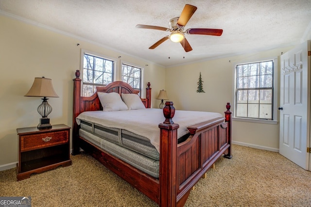 bedroom featuring ceiling fan, light colored carpet, a textured ceiling, and ornamental molding