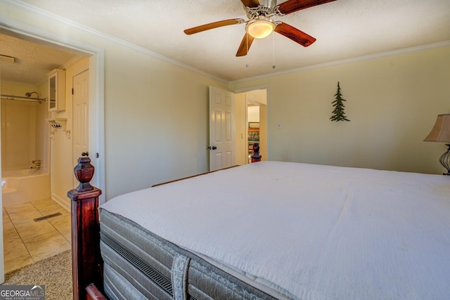 tiled bedroom with ceiling fan, ornamental molding, a textured ceiling, and connected bathroom