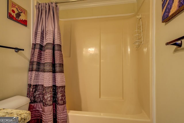 bathroom with shower / tub combo and toilet