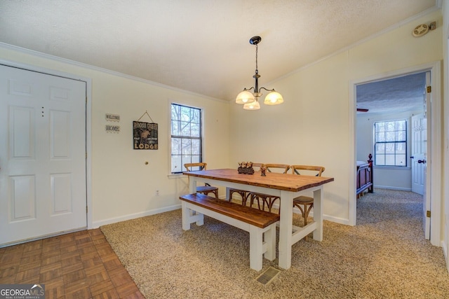 dining area with a notable chandelier, parquet floors, a textured ceiling, and ornamental molding