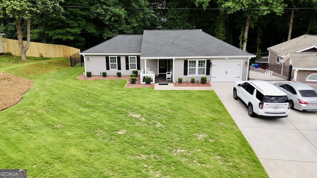 view of front of home featuring a garage and a front lawn