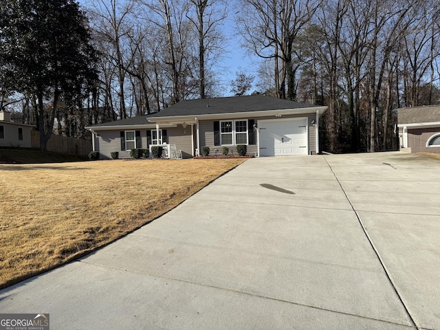 ranch-style home featuring covered porch and a garage