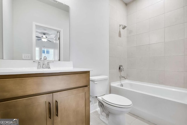 full bathroom featuring ceiling fan, tile patterned flooring, toilet, vanity, and tiled shower / bath