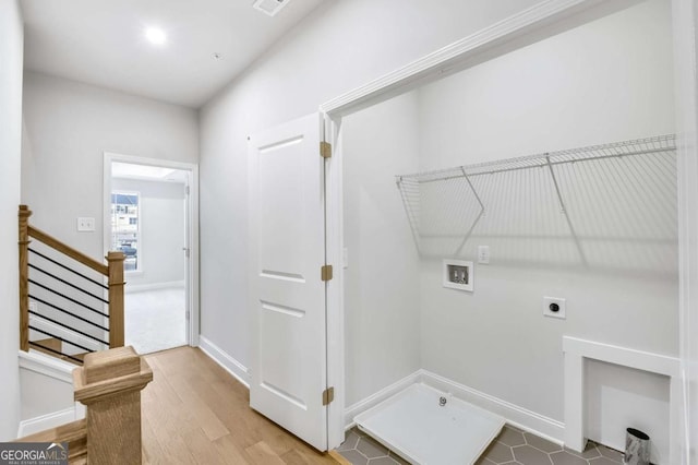 laundry room with hardwood / wood-style flooring, washer hookup, and hookup for an electric dryer