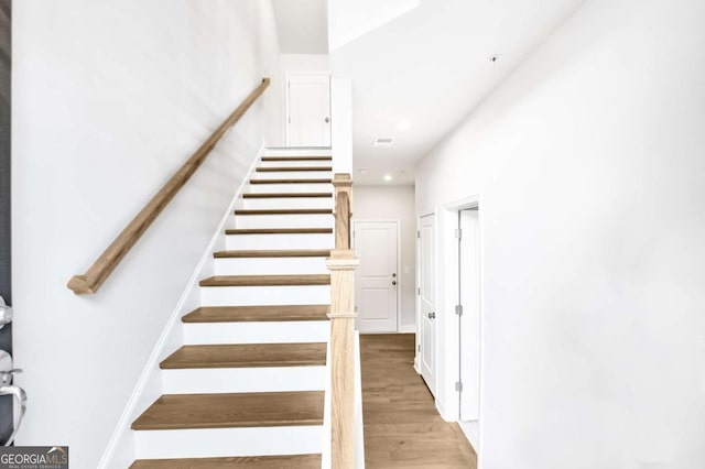 stairway featuring hardwood / wood-style floors